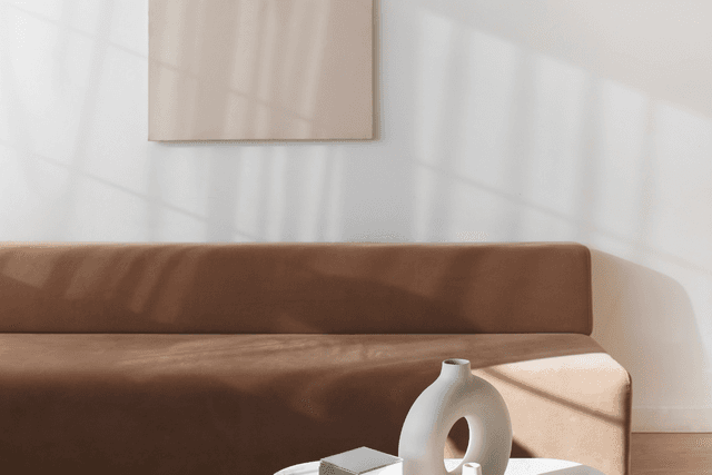 Minimal living room with warm-toned sofa and ceramic décor