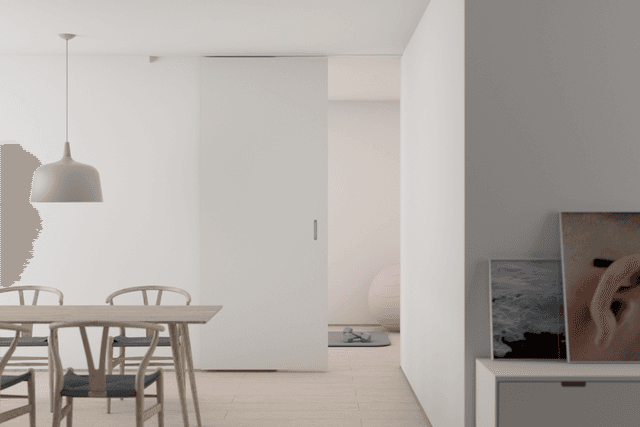 Open plan dining area with sliding door and soft lighting