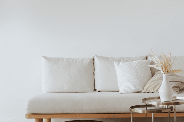 Minimal sofa setup with side tables and simple décor