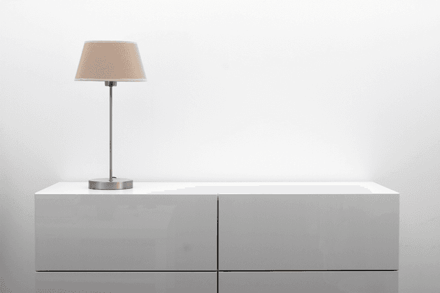 Minimal cabinet and table lamp in a bright interior